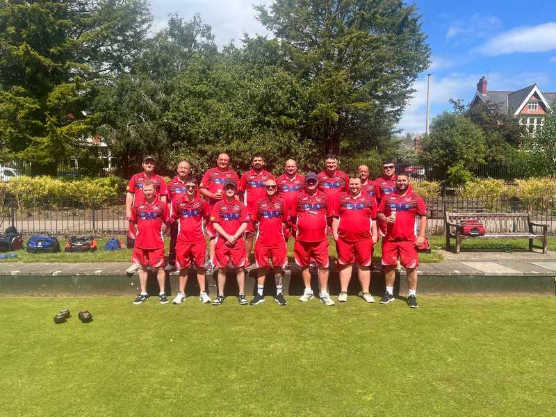 The Blaenrhondda bowls team in their red shirts on the green